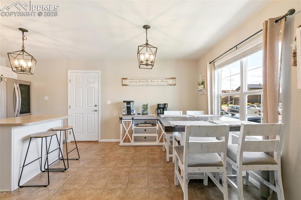 Image 7 of 27: Dining room featuring a chandelier