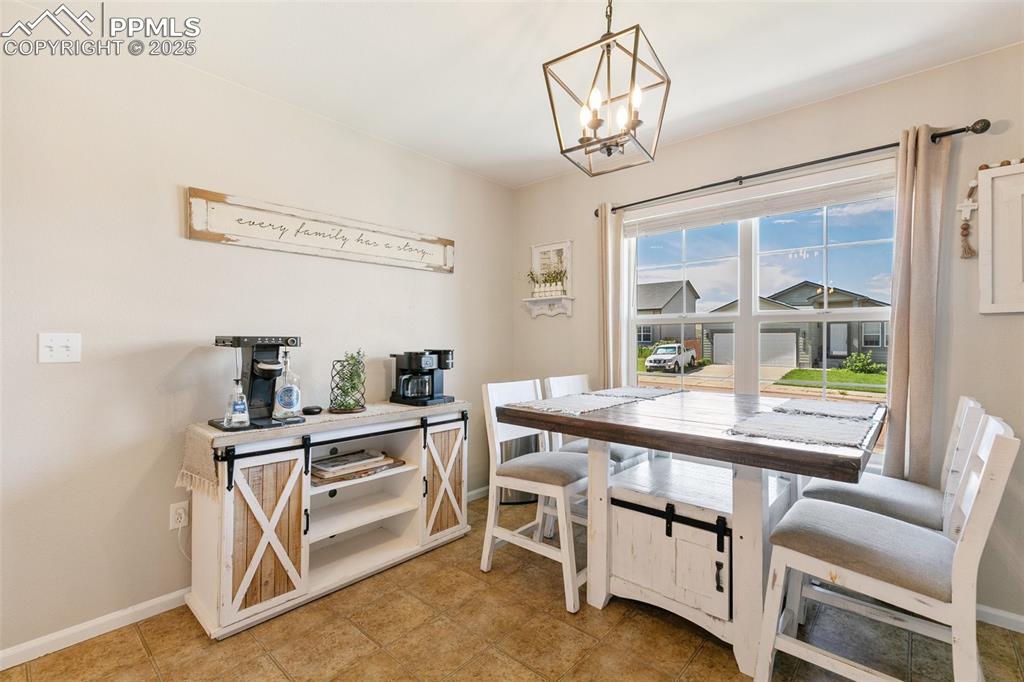 Image 8 of 27: Dining area with a chandelier and baseboards