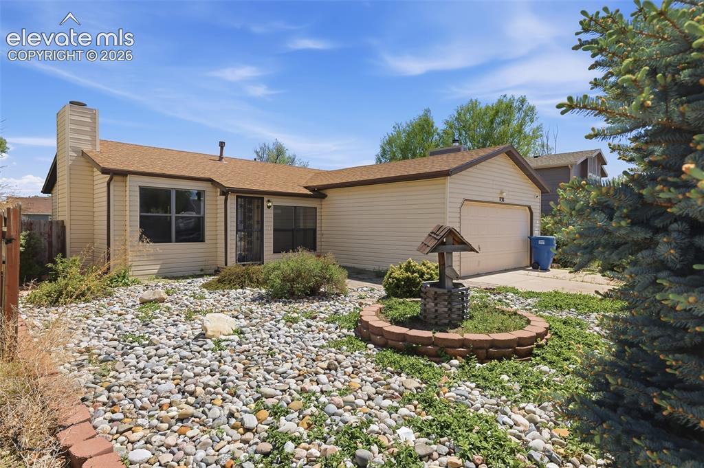 Image 1 of 29: Single-story residence featuring light-colored siding, an attached garage, 