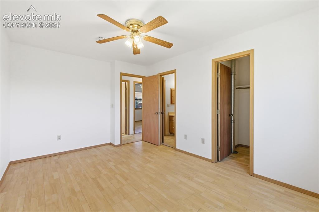 Image 15 of 29: Spacious room featuring light wood-finish flooring, white walls, and a ceil