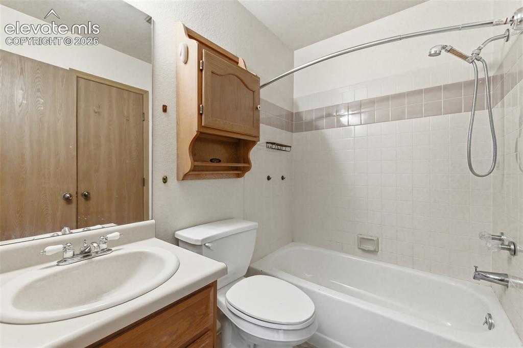 Image 17 of 29: Bathroom featuring a vanity with an integrated sink and chrome faucet, a to