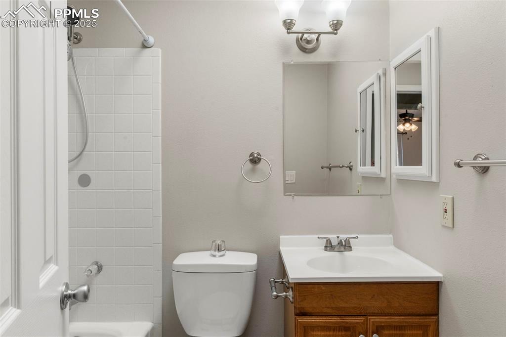 Image 18 of 24: Bathroom featuring vanity and shower / washtub combination