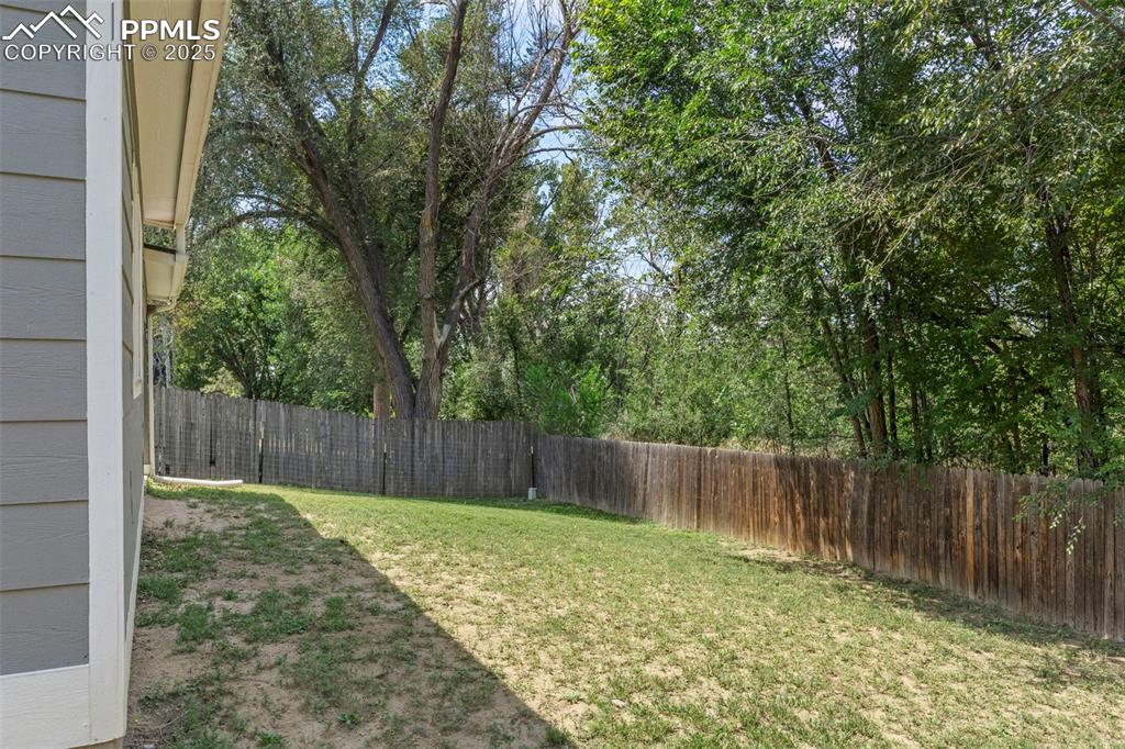 Image 22 of 24: View of fenced backyard