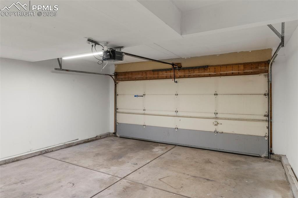Image 23 of 24: Garage featuring a garage door opener