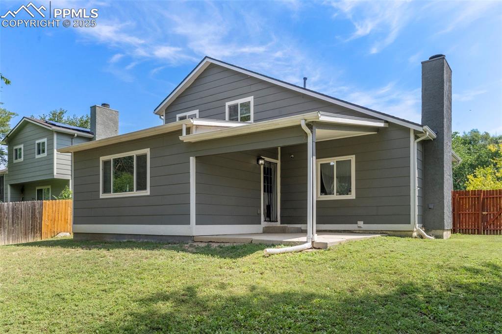 Image 24 of 24: Rear view of house with a chimney