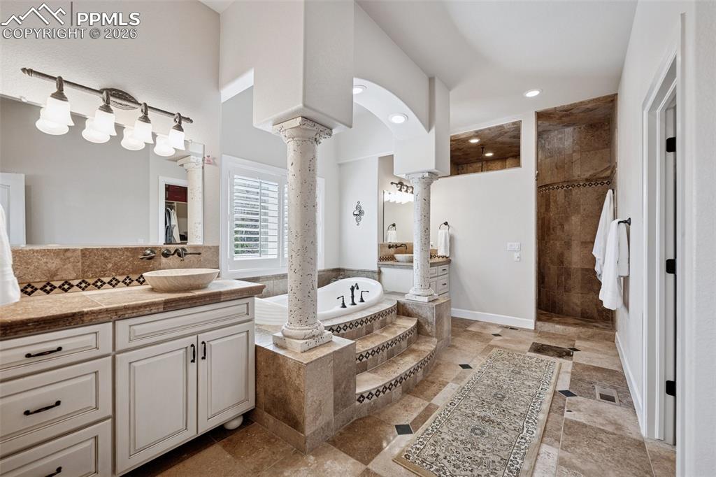 Image 23 of 50: Bathroom with recessed lighting, ornate columns, vanity, a walk in shower, 