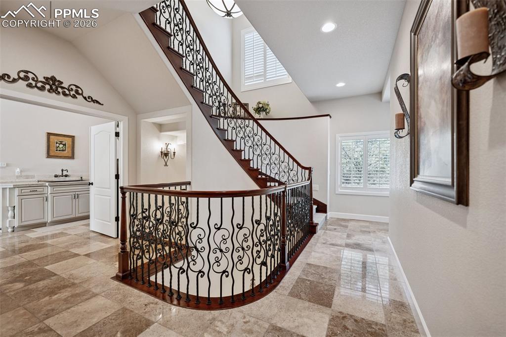 Image 24 of 50: Hall featuring recessed lighting, baseboards, and a sink