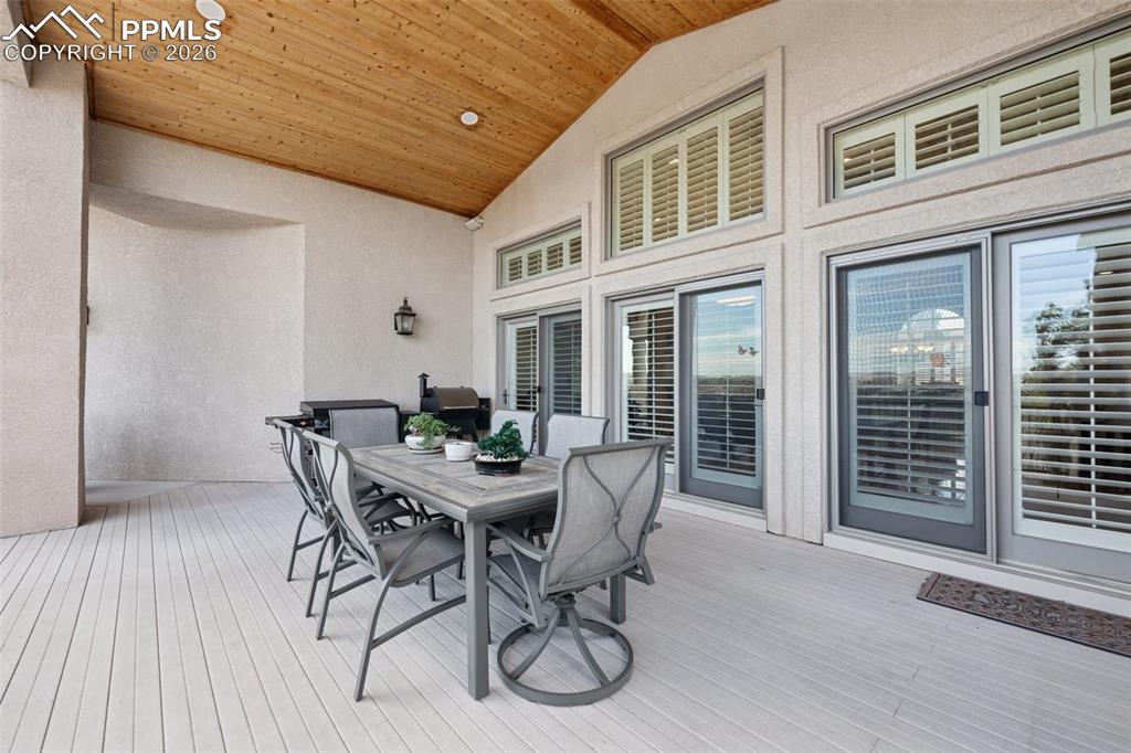 Image 45 of 50: Wooden terrace featuring outdoor dining space