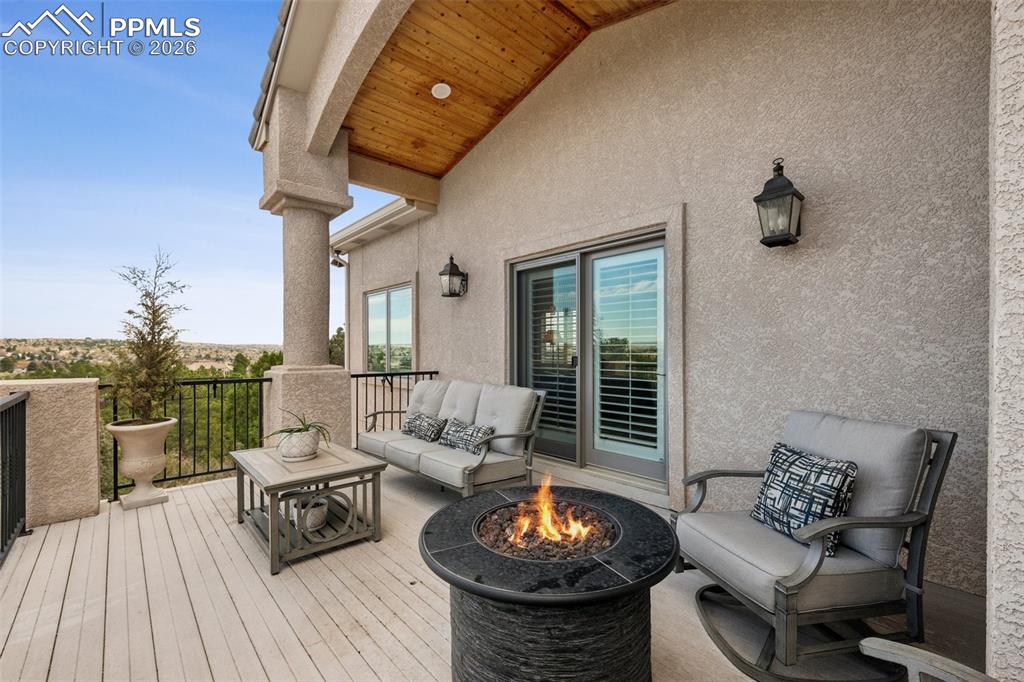 Image 46 of 50: Wooden deck featuring an outdoor fire pit