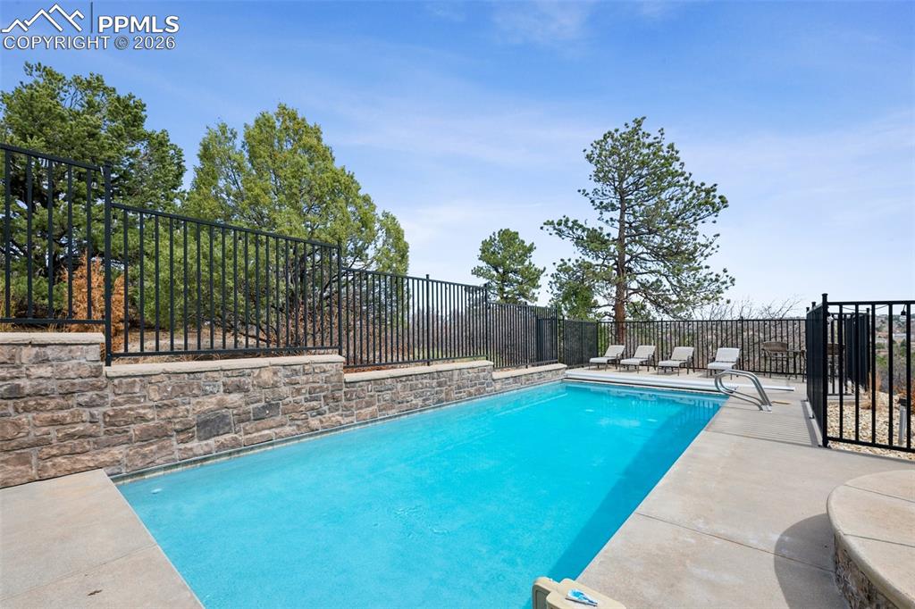 Image 47 of 50: View of swimming pool featuring a fenced backyard, a patio, and a fenced in