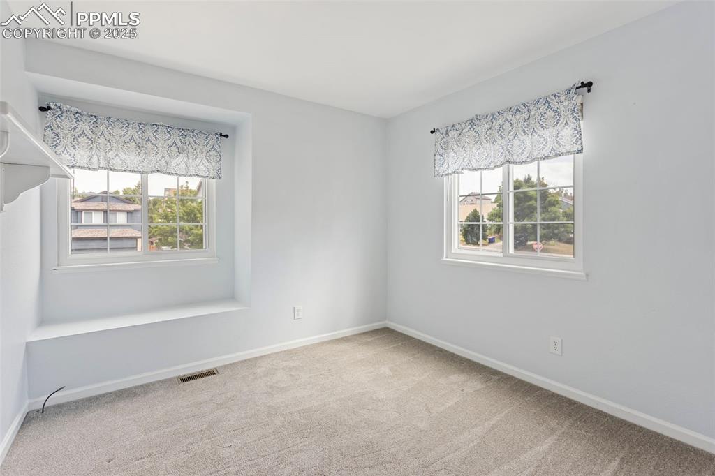 Image 14 of 37: Unfurnished room with healthy amount of natural light and light colored car