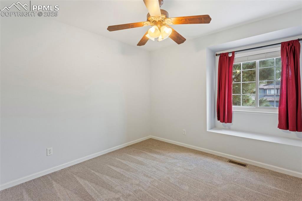 Image 16 of 37: Unfurnished room featuring light colored carpet and a ceiling fan