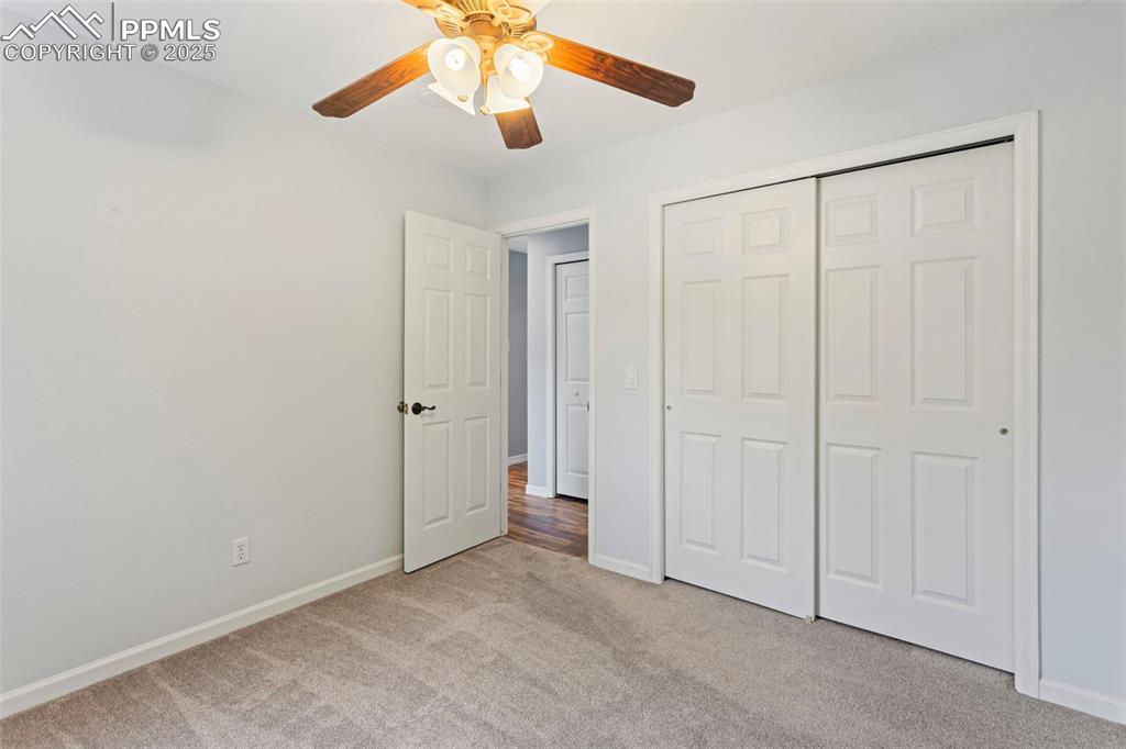 Image 17 of 37: Unfurnished bedroom with carpet, a closet, and a ceiling fan