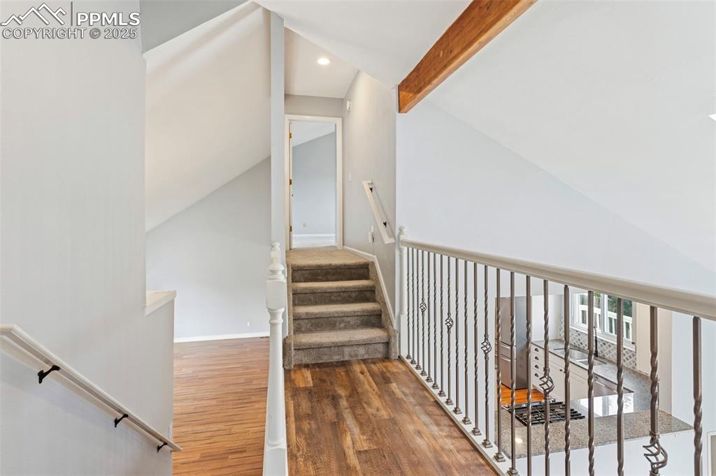 Image 21 of 37: Stairs with wood finished floors and recessed lighting