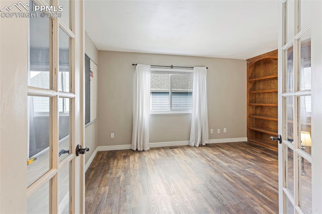 Image 22 of 37: Unfurnished room featuring french doors, plenty of natural light, and wood