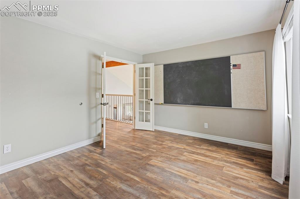 Image 23 of 37: Spare room with wood finished floors and french doors