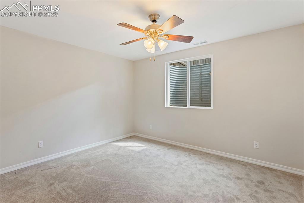 Image 28 of 37: Spare room featuring carpet floors and a ceiling fan