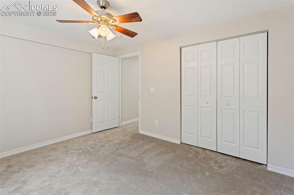 Image 29 of 37: Unfurnished bedroom featuring light carpet, a closet, and ceiling fan