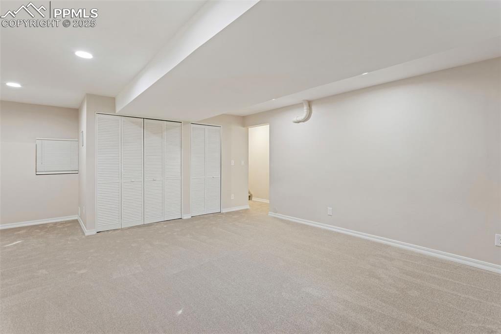 Image 32 of 37: Finished basement with carpet floors and recessed lighting