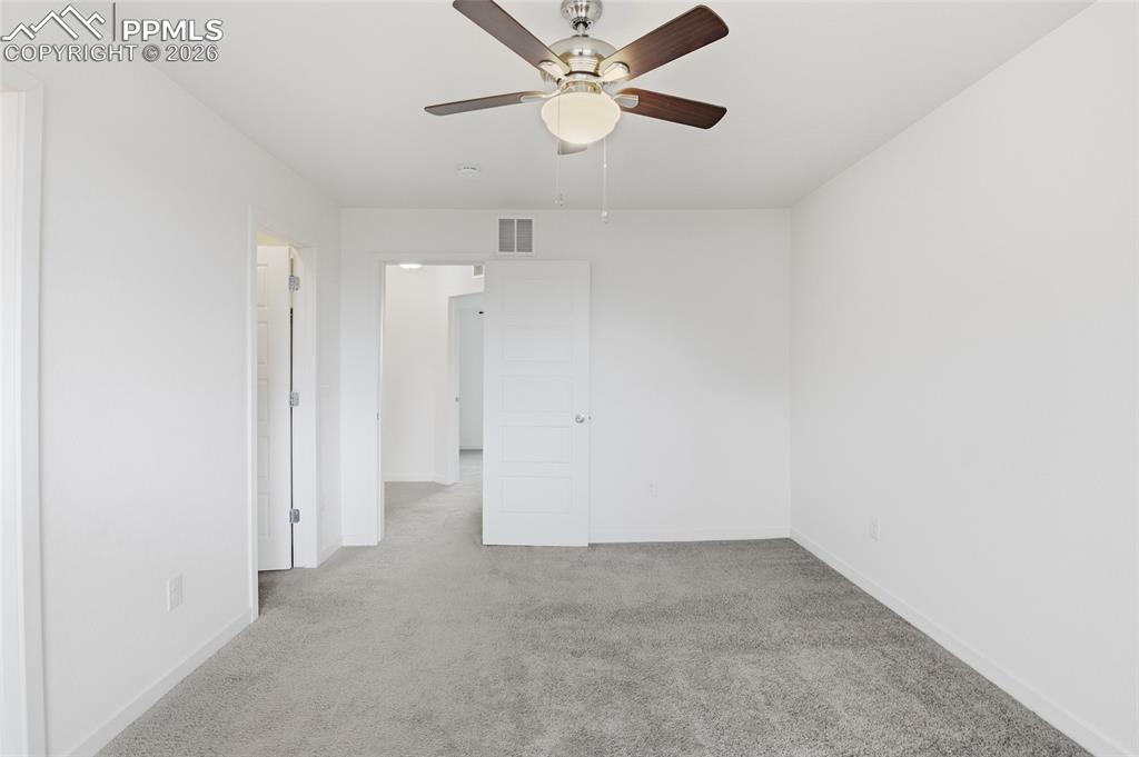Image 14 of 29: Spare room with light colored carpet and ceiling fan