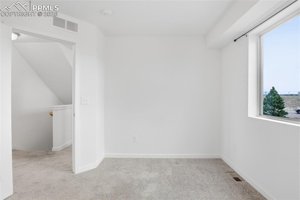 Image 19 of 29: Unfurnished room with light carpet