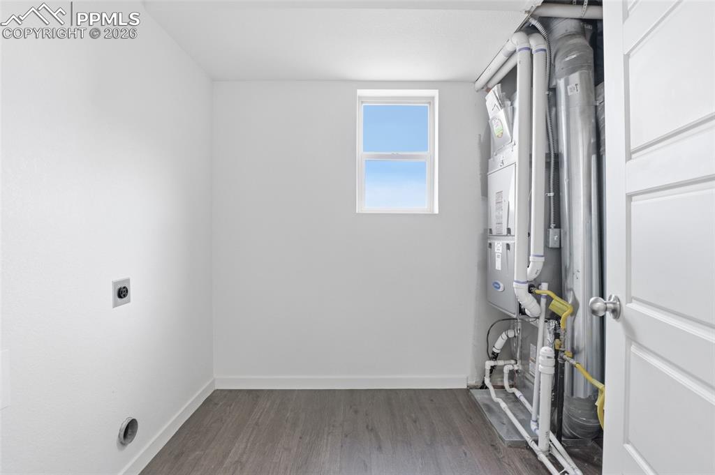 Image 20 of 29: Laundry area featuring light wood-style flooring, heating unit, and hookup 