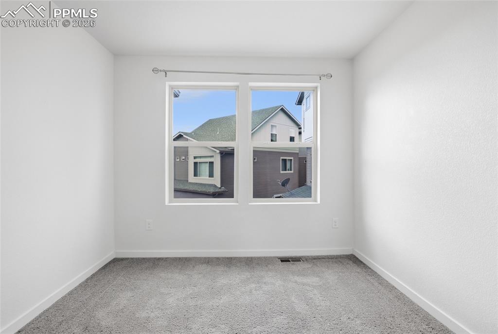 Image 21 of 29: Spare room with light carpet and baseboards