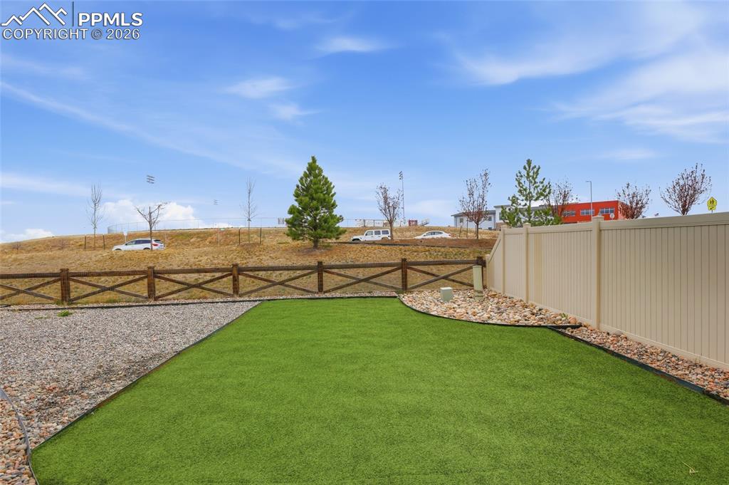 Image 25 of 29: View of fenced backyard