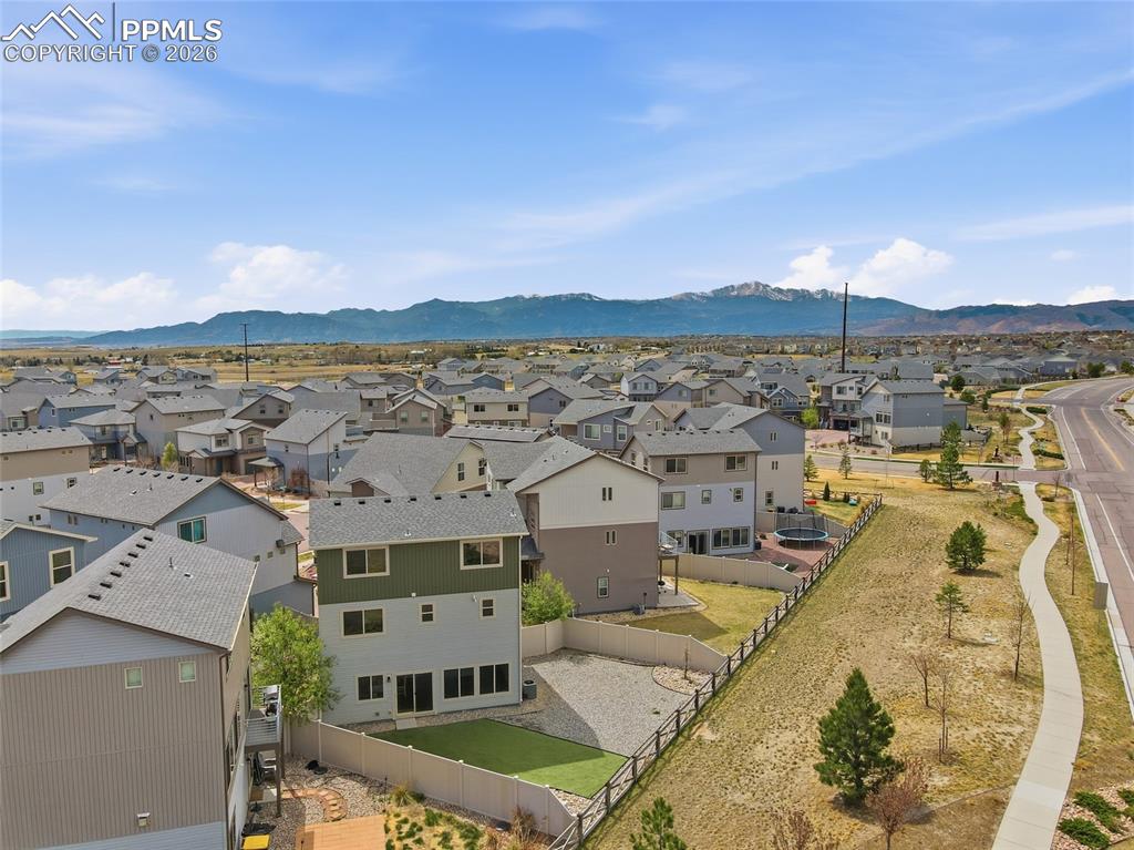 Image 29 of 29: Aerial view of residential area featuring a mountain backdrop