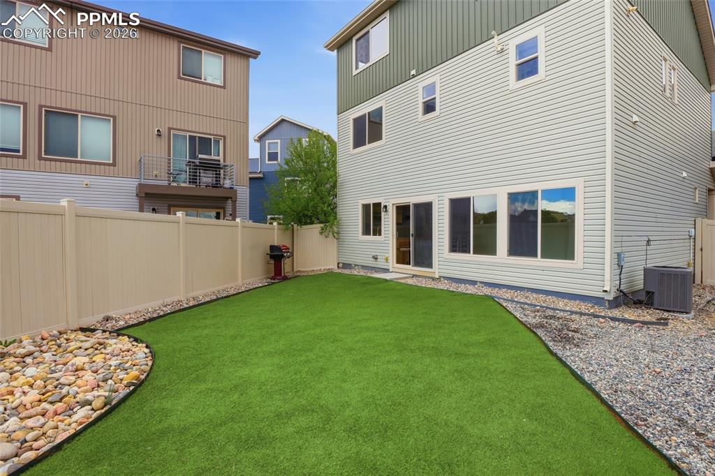 Image 5 of 29: Rear view of property with a fenced backyard