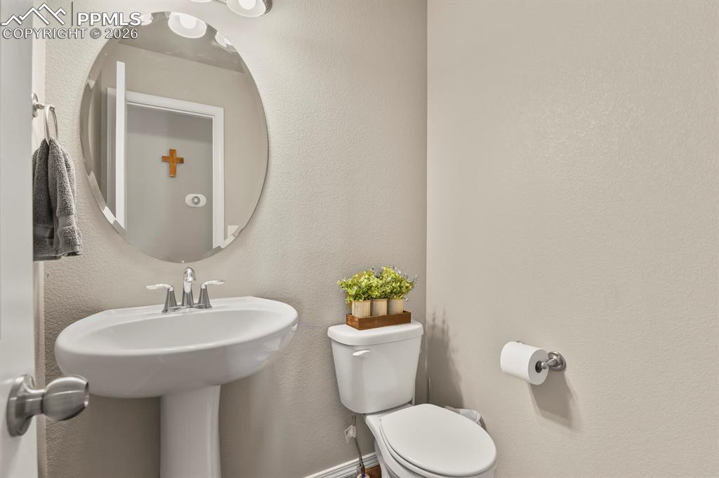 Image 11 of 49: Half bathroom located on the main level 