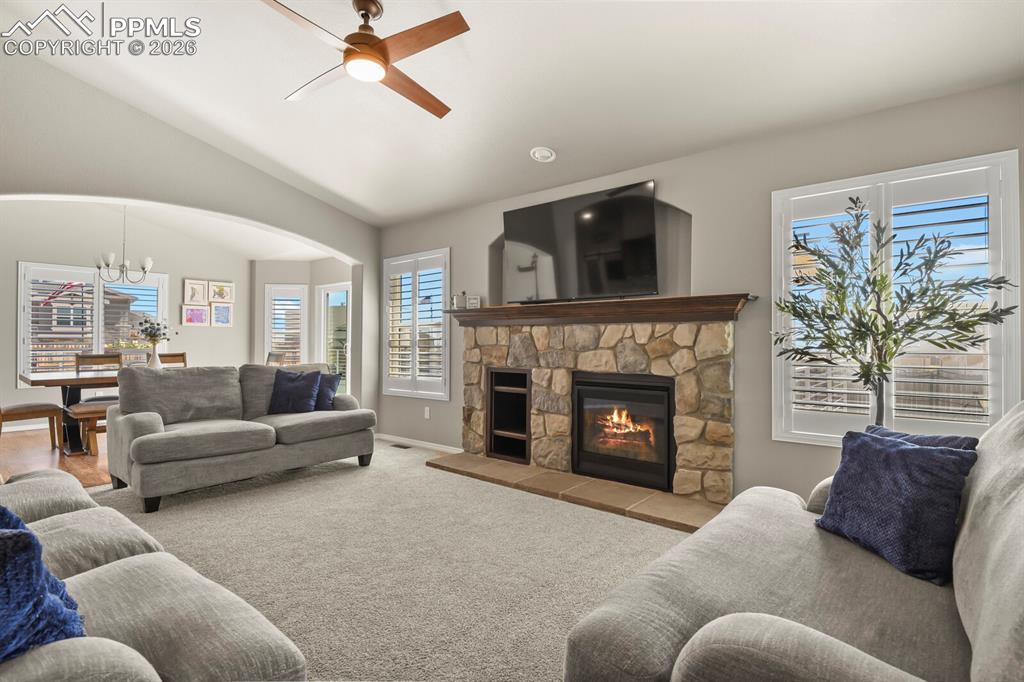 Image 13 of 49: Living room features a gas fireplace, built-in shelves, and a tv niche