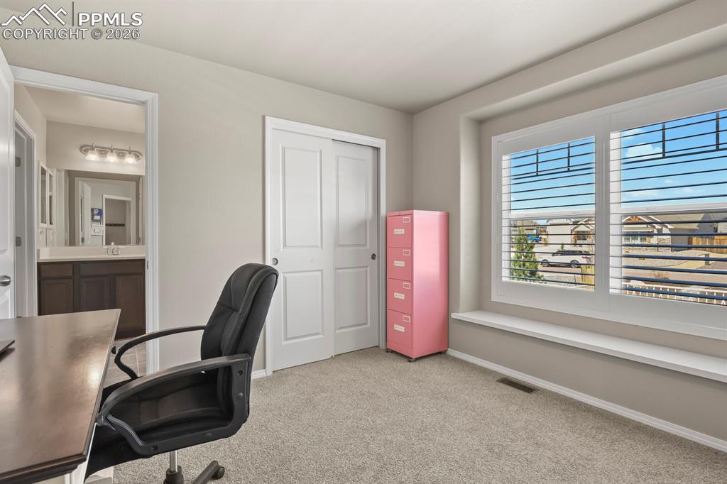 Image 6 of 49: Secondary bedroom #1 is currently being used as an office.