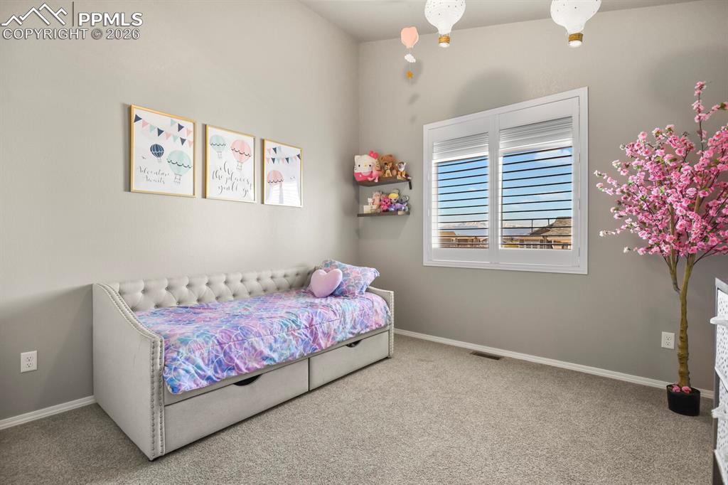 Image 9 of 49: Secondary bedroom #2 has a view of Pikes Peak. 