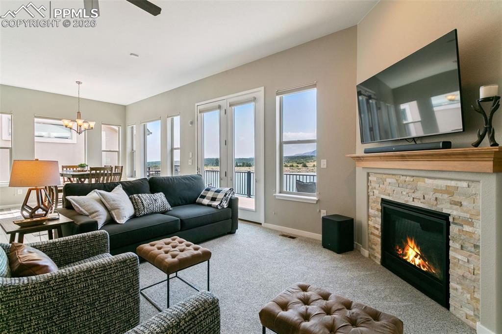Image 12 of 50: Living Room featuring Stone Fireplace