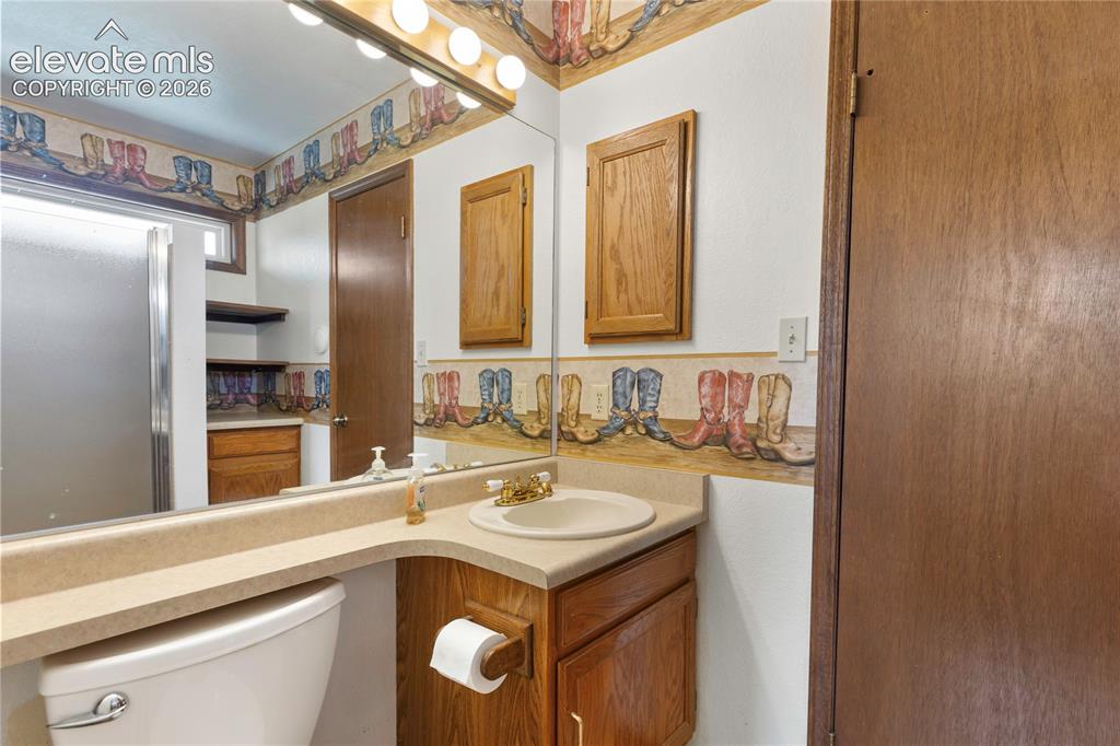 Image 19 of 26: 2 of 2 upper level bathrooms divided with a pocket door.
