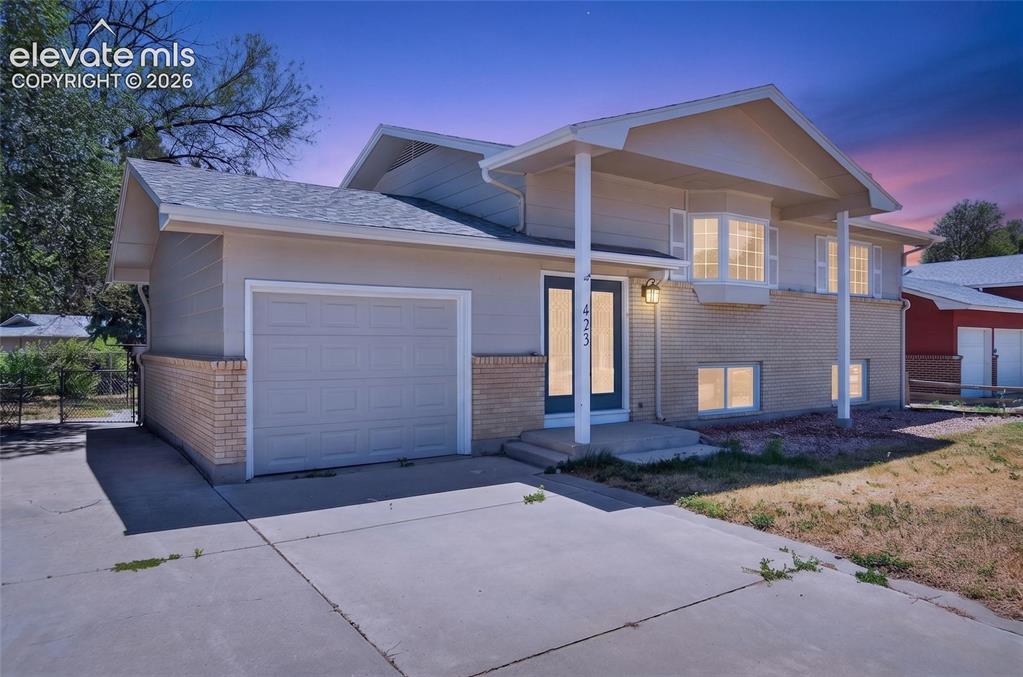 Image 1 of 21: Split-level residence featuring a brick and siding exterior