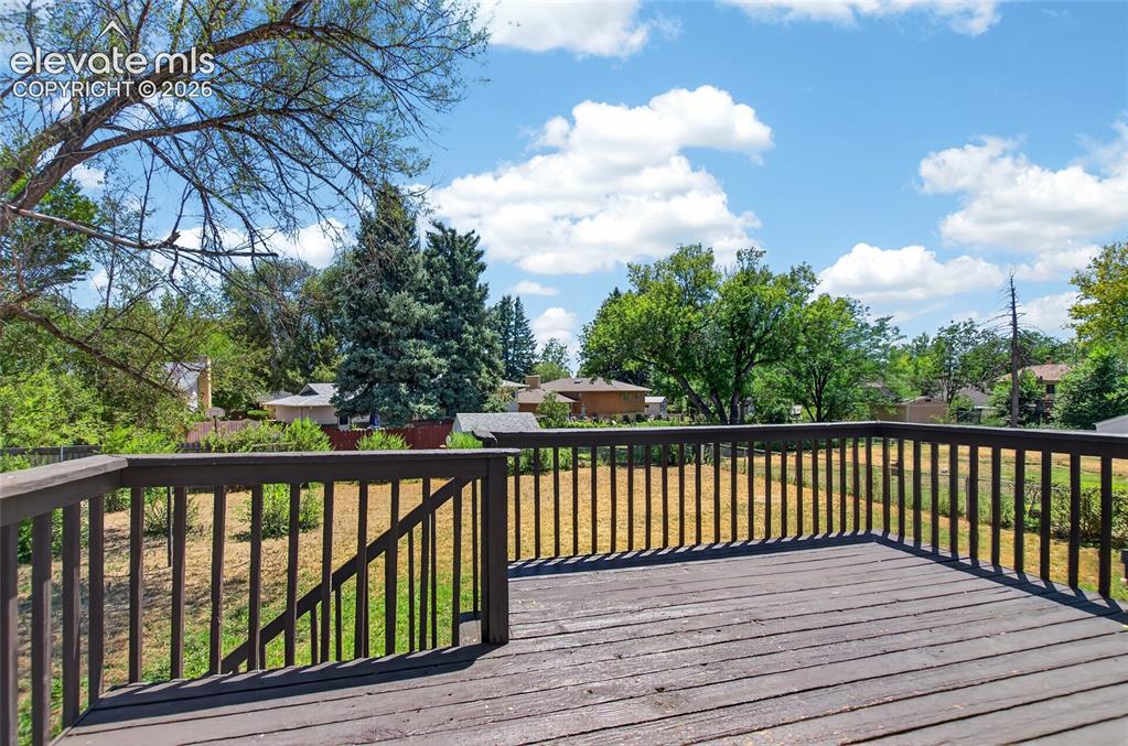 Image 9 of 21: Elevated outdoor deck with wood-finish flooring and full railing
