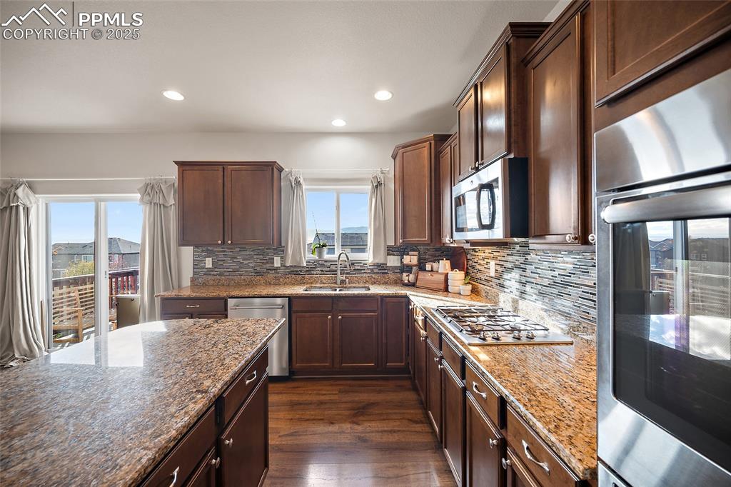Image 11 of 50: Double ovens and gas cook top.