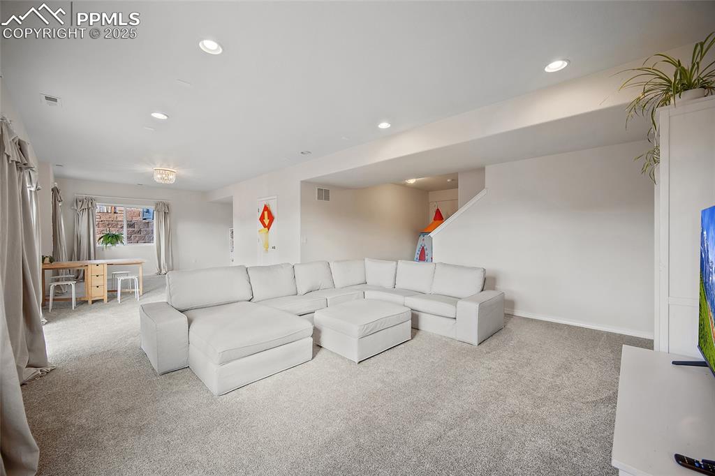 Image 19 of 50: Lower-level open floor plan with plenty of room for pool table or ping pong