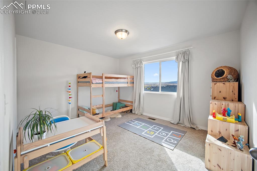 Image 20 of 50: Upper-Level Bedroom with walk in closet.