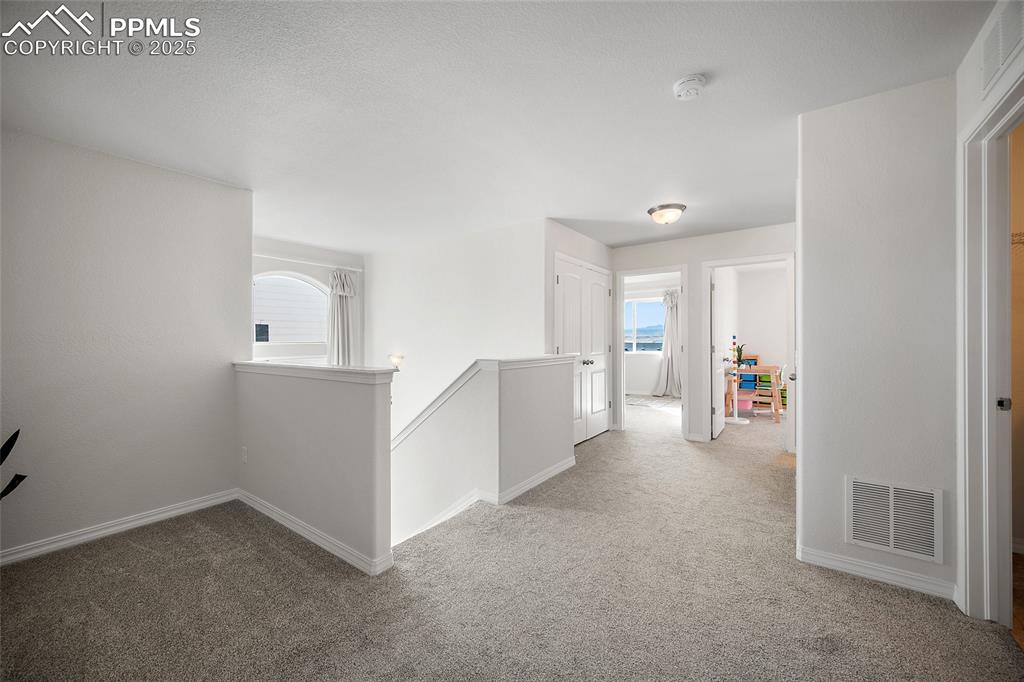 Image 32 of 50: Spacious hallway leading to the hard to find 4 bedrooms on the upper level.