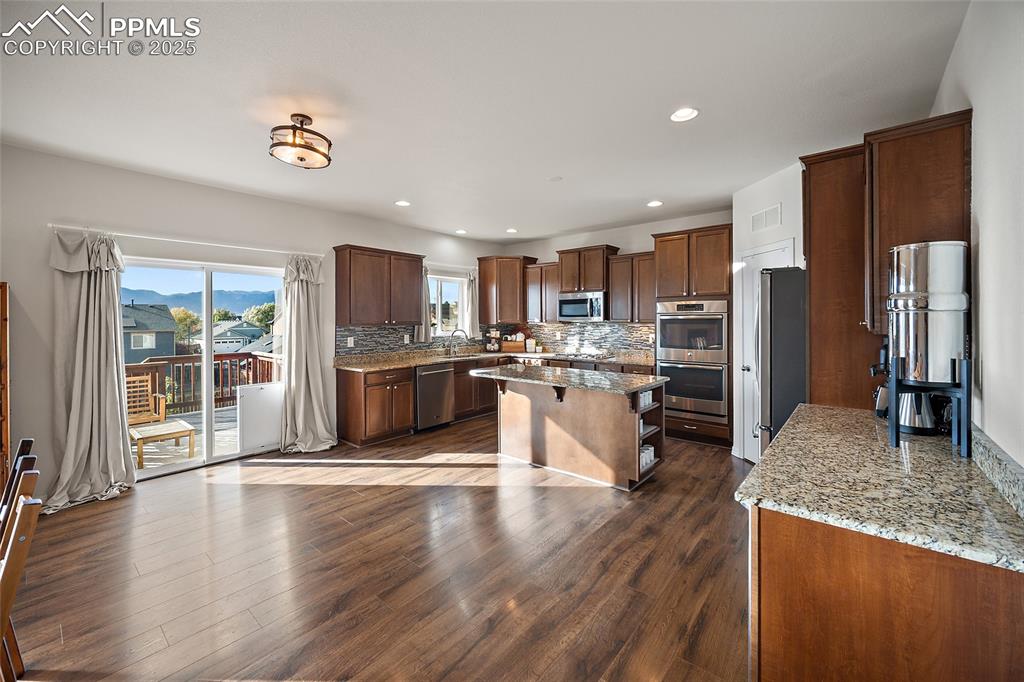 Image 8 of 50: Tons of counter space and cabinets with walk out to the deck for your BBQ