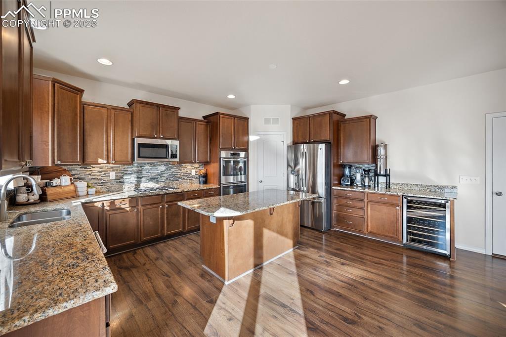 Image 9 of 50: Heart of the home! Granite counter tops and breakfast island. Extra counter