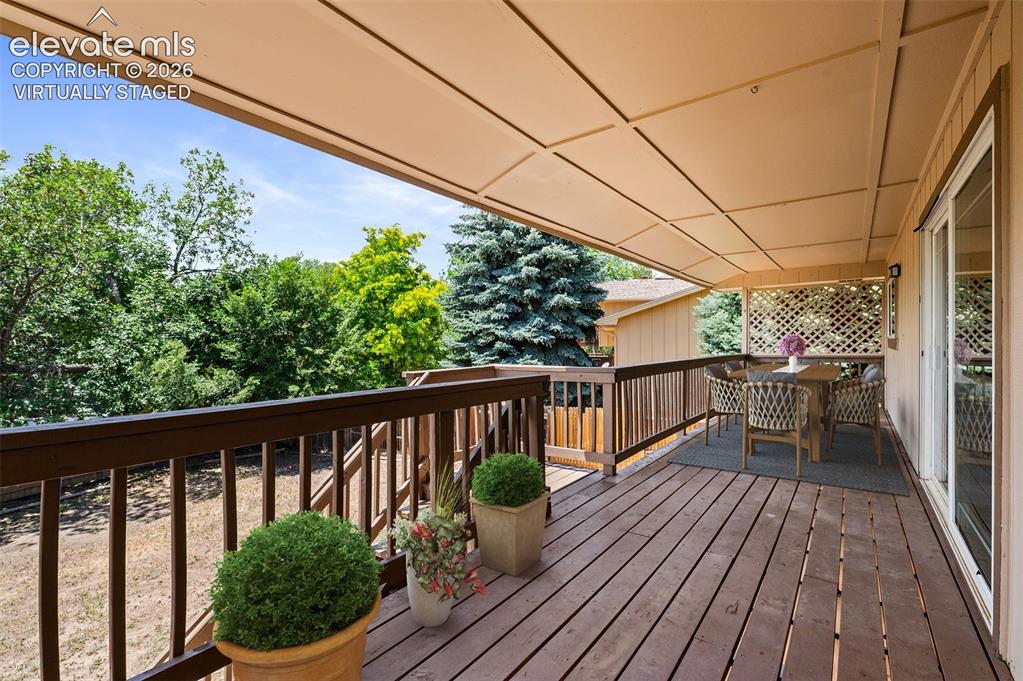 Image 35 of 50: Virtually Staged; Upper Covered Deck Off of Kitchen & Den
