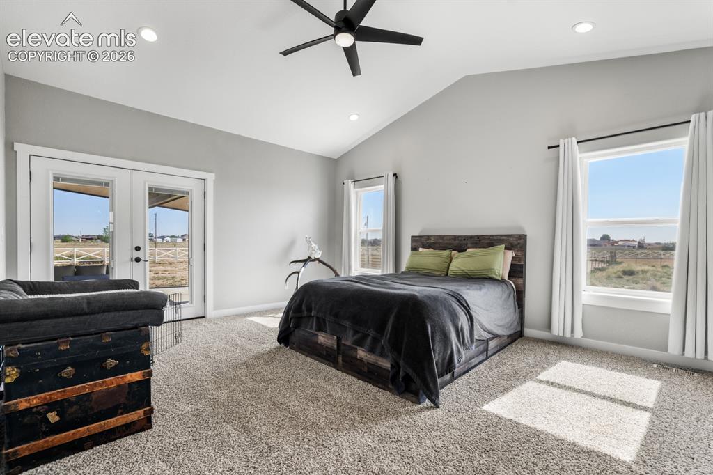 Image 13 of 50: Bedroom with vaulted ceilings, recessed lighting, and a black ceiling fan