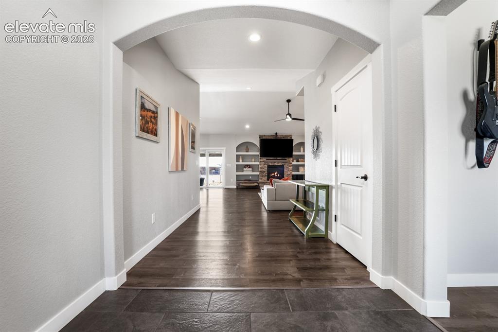 Image 18 of 50: Arched entryway leading to a spacious interior