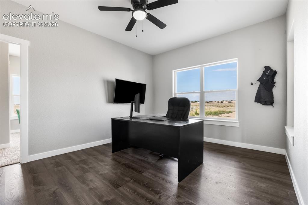 Image 19 of 50: Spacious room featuring wood-finish flooring, light gray walls, a ceiling f