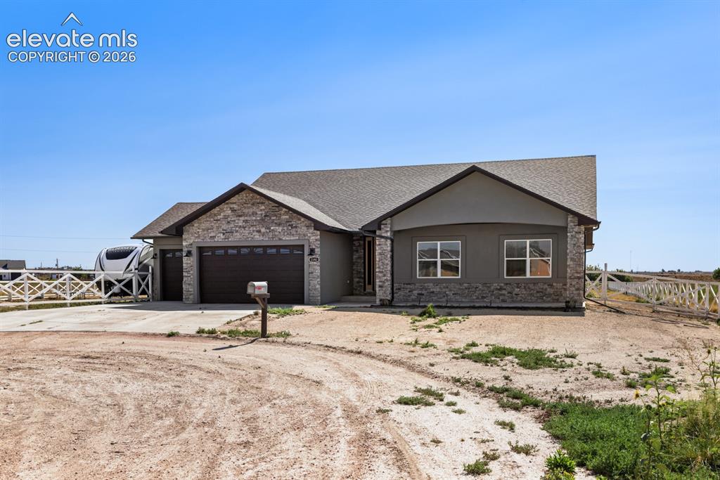Image 2 of 50: Ranch-style residence featuring stone and stucco exterior finishes
