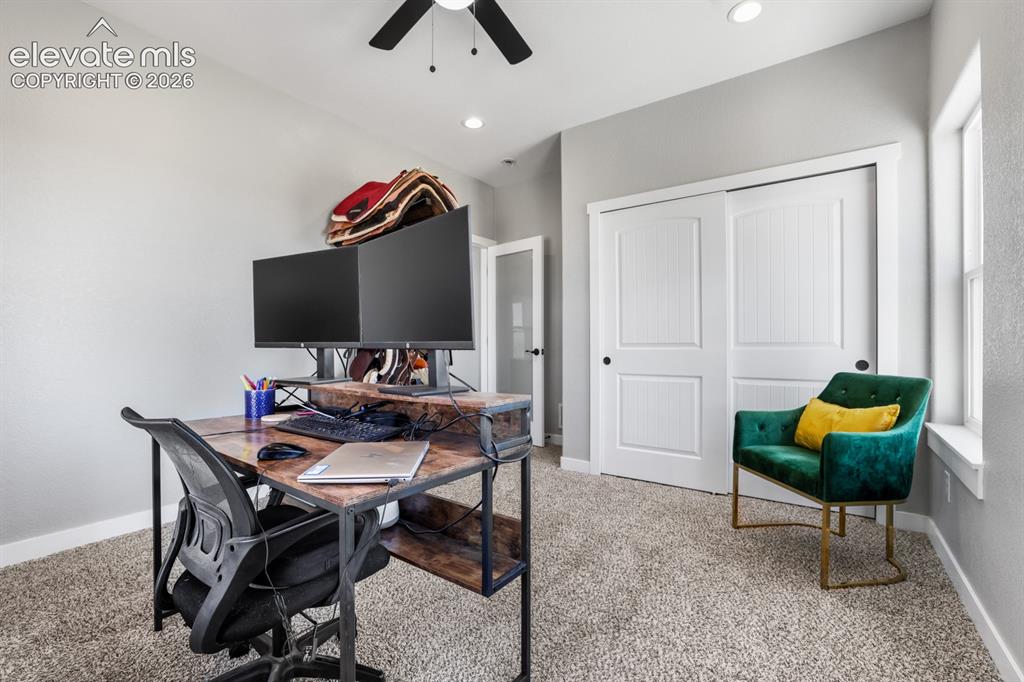 Image 23 of 50: Carpeted room featuring a ceiling fan, recessed lighting, and a window with